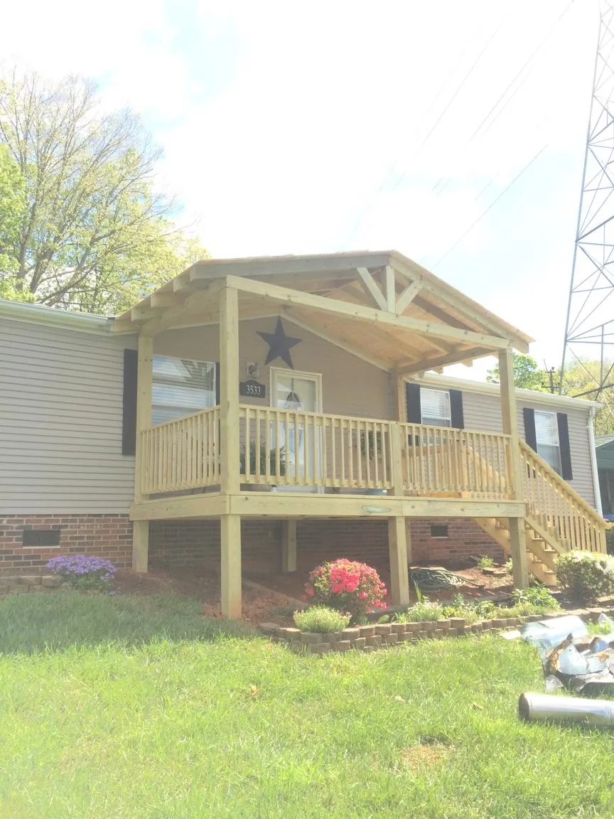New gabled porch roof and deck railing added to a ranch home in Mamaroneck